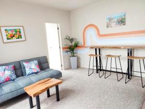 a living room with a couch and a piano at City Garden Penthouse in Auckland