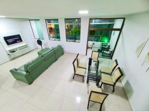 a living room with a couch and a table and chairs at Casa em Porto de Galinhas by AFT in Porto De Galinhas