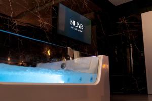 a bathroom sink with a sign on the wall at Nuar suite&spa in Palermo