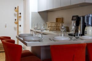 a kitchen with a table with plates and wine glasses at Le royaume de Fabrice in Suresnes