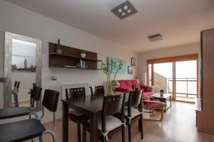 a living room with a table and chairs and a couch at Descansar, sonreír, sentir. Paraíso frente al mar in Santa Pola