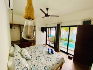 a bedroom with a bed and a view of a pool at Oasis Villa a lado del mar in Brisas de Zicatela