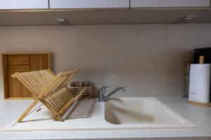 a kitchen sink with a chair sitting next to it at Le royaume de Fabrice in Suresnes