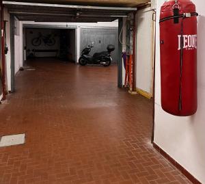 an empty garage with a motor scooter parked in it at Casa La Dolce Pesca in Genoa