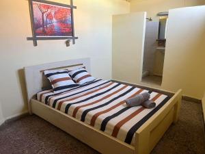 a bedroom with a bed with a teddy bear on it at EspaviR in Antananarivo