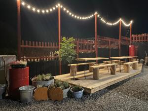 a patio with tables and potted plants and lights at Wioska w Sowich Sokolec in Sokolec