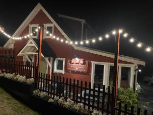 a restaurant with lights on the roof at night at Wioska w Sowich Sokolec in Sokolec
