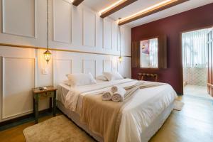 Кровать или кровати в номере Pousada Arvoredo