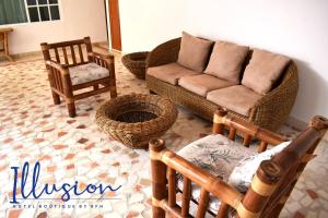 a living room with a couch and two chairs at Illusion Boutique "Near Beach" in Playa del Carmen