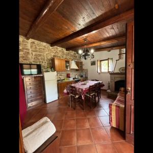 a kitchen with a table and a dining room at Summer House in Fondi