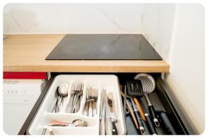 a drawer filled with utensils in a refrigerator at Qhome 3 - Duplex Cosy entre Paris et Disney - Parking privé in Villiers-sur-Marne