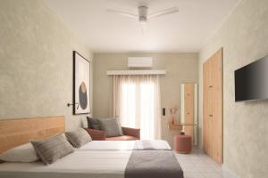 a bedroom with a large bed and a television at Apollo Plakias in Plakias