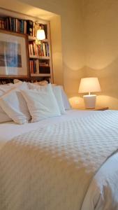 a bedroom with a white bed with a lamp at Candelaria House Boutique in Bogotá