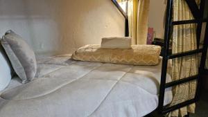 a bed with a pillow on top of it at Casa Samor La Candelaria in Bogotá