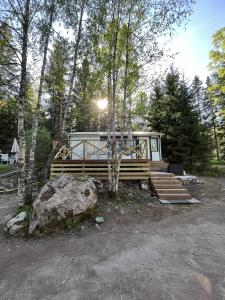 a cabin in the woods with a large rock at Modern Forest Retreat in Örebro