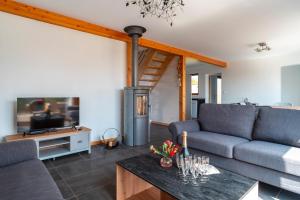 Una sala de estar con un sofá y una chimenea. en Cocon vert proche mer, en Plouhinec