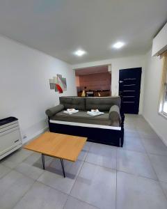 a living room with a couch and a table at Complejo calle Cordoba Departamento 2 in General Roca