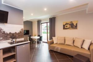 a living room with a couch and a table at Apartamenty Dawna Wisła in Wisła