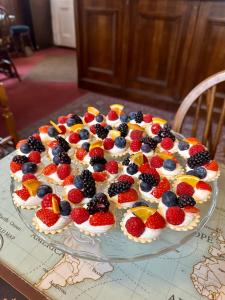 a cake with fruit on top of a map at Cross Keys Hotel Chatteris in Chatteris