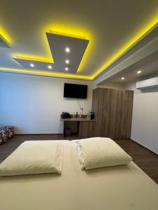 a bedroom with a large bed with a tv on the ceiling at Pension Zwei A in Leverkusen +59 photos