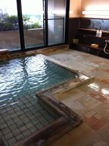 a pool of water in a hotel room at Hosonokan in Hakuba