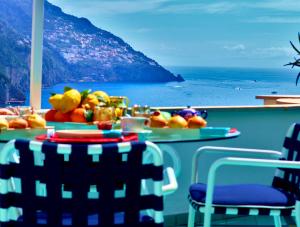 a table with fruit on it with a view of the ocean at Villa Positano with sea view ! in Positano