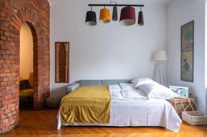 a bedroom with a bed and a brick wall at Bricks & Bikes in Zagreb