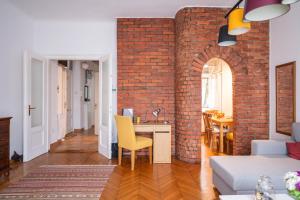 a living room with a brick wall and a desk at Bricks & Bikes in Zagreb