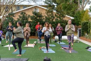 a group of people doing yoga on the grass at Oyster Bay Boutique Hotel in Pensacola