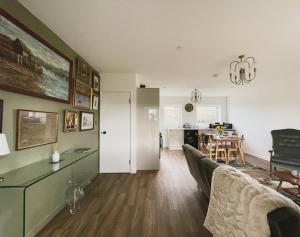 a living room with a couch and a table at Ty Ray Penmaes in Rhayader