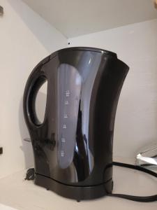 a black tea kettle sitting on a counter at Paradise Comfort in Koror