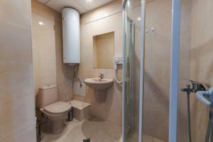 a bathroom with a toilet and a sink and a shower at ALVA in Sandanski +11 photos