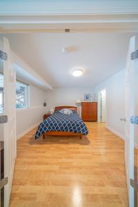 a bedroom with a bed and a wooden floor at Alaskan Sunset House - Ground Floor Unit in Anchorage