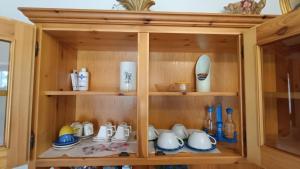 a wooden cabinet filled with cups and dishes at Il Fiordaliso in Preci