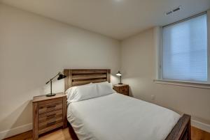 A bed or beds in a room at South Main Residences by Surf Hotel