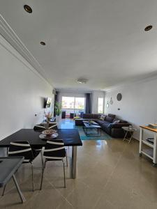 a living room with a table and a couch at Asilah Marina Golf Sea Ocean and Golf view in Asilah