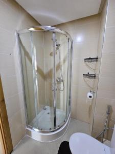 a shower with a glass door in a bathroom at Asilah Marina Golf Sea Ocean and Golf view in Asilah