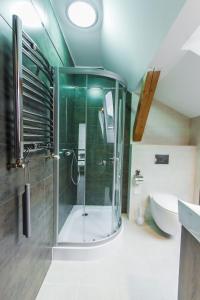 a bathroom with a shower and a sink and a tub at Apartamenty Dawna Wisła in Wisła