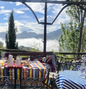 een tafel en stoelen met uitzicht op de bergen bij Gîte de montagne Azilane in Izilane