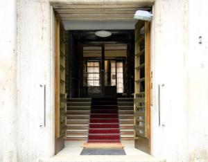 a hallway with stairs and a red carpet at Athena Guest House in Rome
