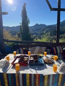 een tafel met borden met voedsel erop met uitzicht bij Gîte de montagne Azilane in Izilane