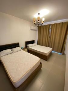 Postel nebo postele na pokoji v ubytování Marassi hotel Apartment