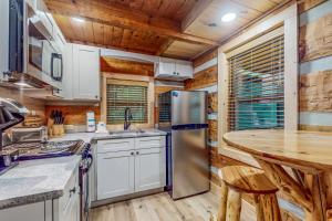 a kitchen with a stainless steel refrigerator and a counter at Up the Creek in Gatlinburg +14 photos