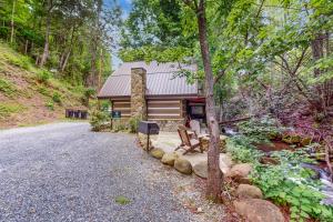 a cabin in the woods with a gravel driveway at Up the Creek in Gatlinburg