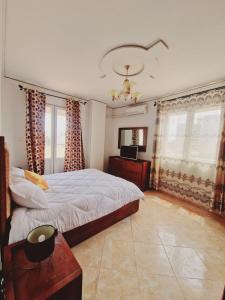 - une chambre avec un lit et une télévision dans l'établissement ORAN Frange Maritime, à Oran