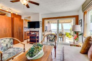 a living room with a couch and a table at Ultimate Oceanfront Townhome with AandC On Kona Coast in Kailua-Kona