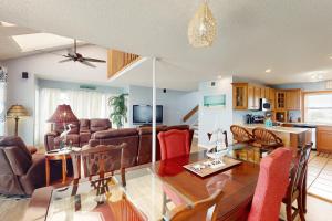 a dining room and living room with a dining table at Lucky Shores in North Topsail Beach