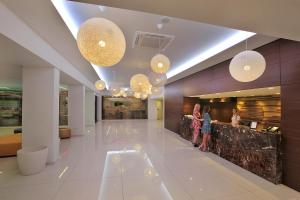 two girls standing in the lobby of a building at Nelia Beach Hotel & Spa in Ayia Napa +37 photos