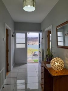 a room with a hallway with a door with a view at Mary Ellen's - Doonalt in Glencolumbkille