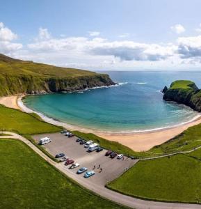 an aerial view of a parking lot next to a beach at Mary Ellen's - Doonalt in Glencolumbkille +16 photos